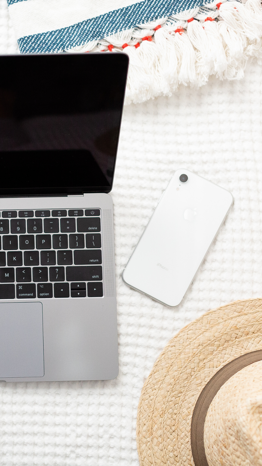 laptop and straw hat and cell phone